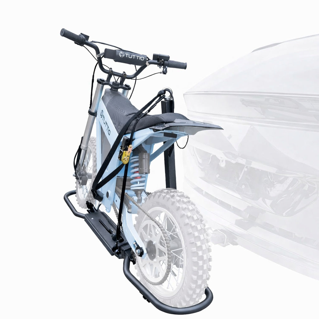 Electric bike secured on hitch mounted carrier rack using a three point fixing system including support post, wheel cradle and tie down straps