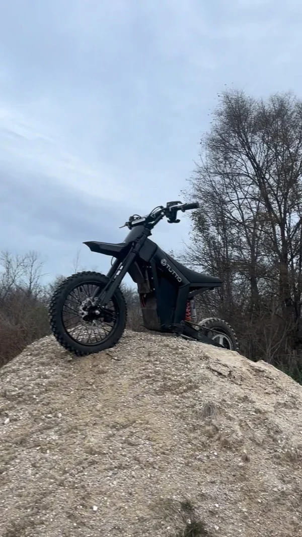 Customer photo showing a Tuttio electric dirt bike on a rocky hill