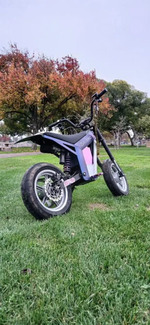 Customer photo of Tuttio SE electric dirt bike parked on grass