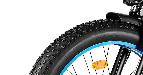 Close-up of the Tuttio Adria26 front wheel with fat tire tread, blue rim, spokes, side reflector, front fork, and fender detail