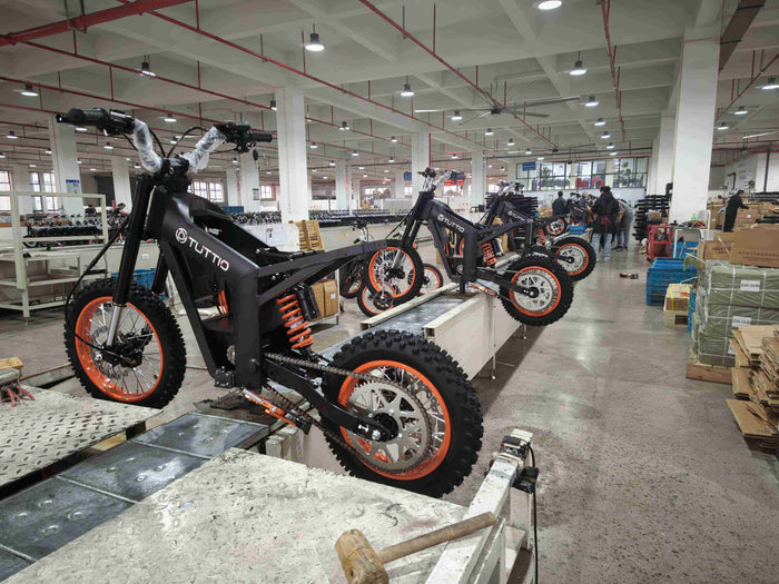 Tuttio electric dirt bikes on final assembly line, retail-ready units assembled and inspected before shipment