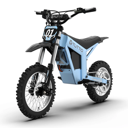 A bright studio shot on a clean white background showcasing the front perspective of the light blue Tuttio Soleil01 GB electric dirt bike, featuring its distinctive '01' number plate and off-road tires.